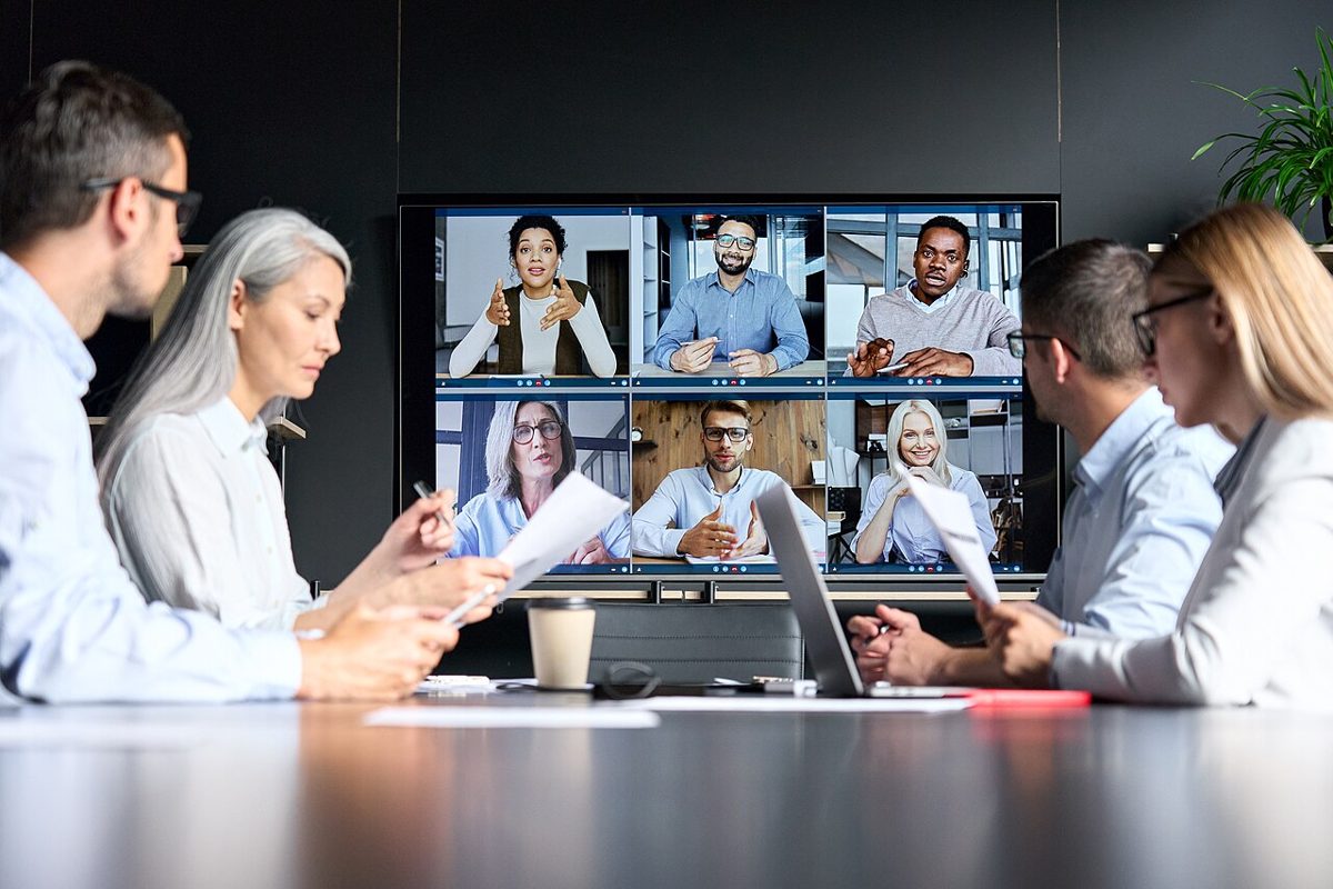 Colleagues in a meeting room on a video call